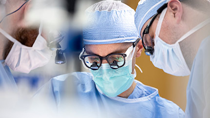 Three Cleveland Clinic doctors in surgery.